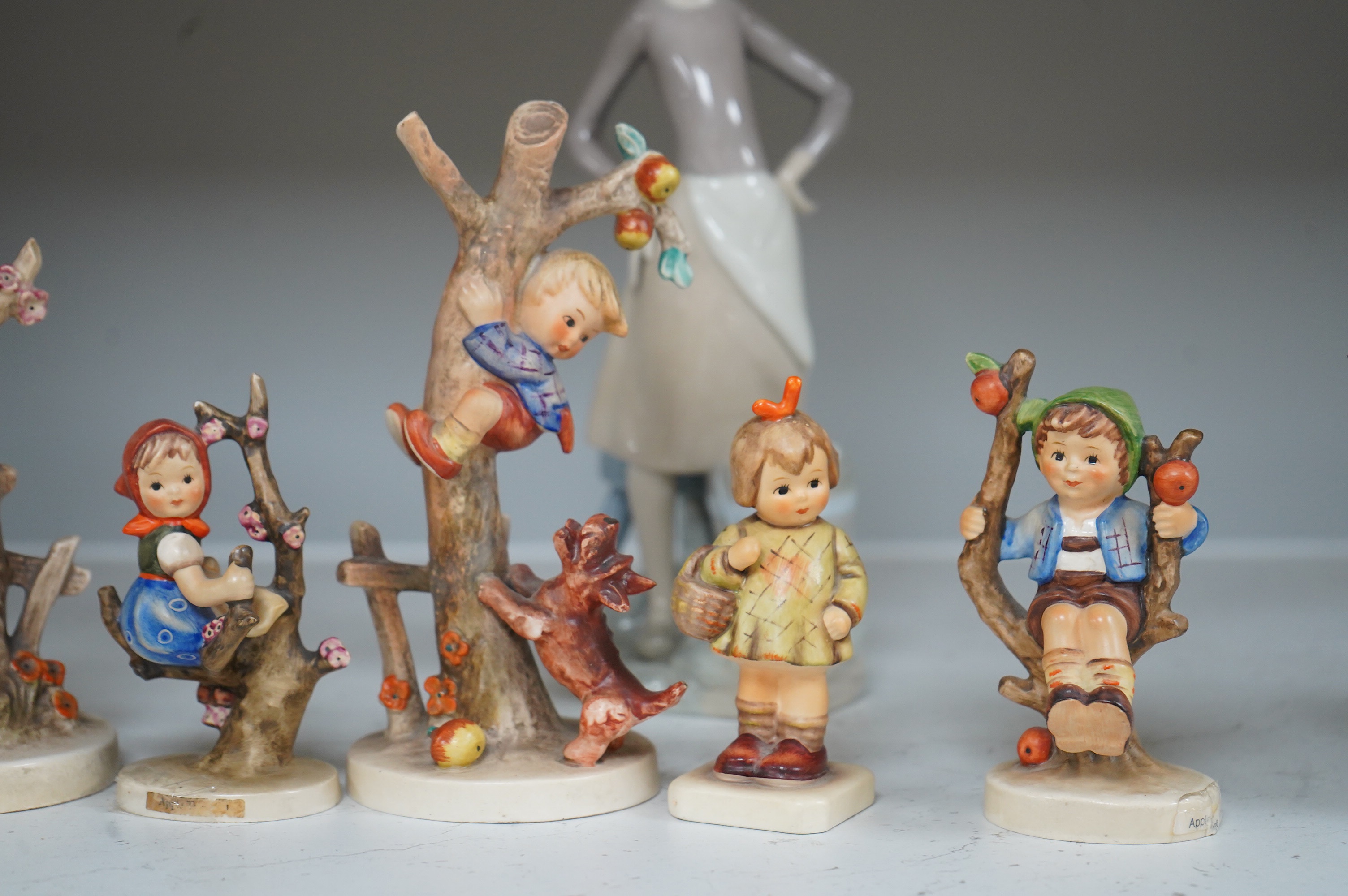 Six various Goebel figures and a Lladro figure, 24cm high